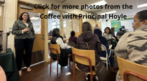 Photo of Principal Hoyle with coffee in hand presenting to parents at meeting.